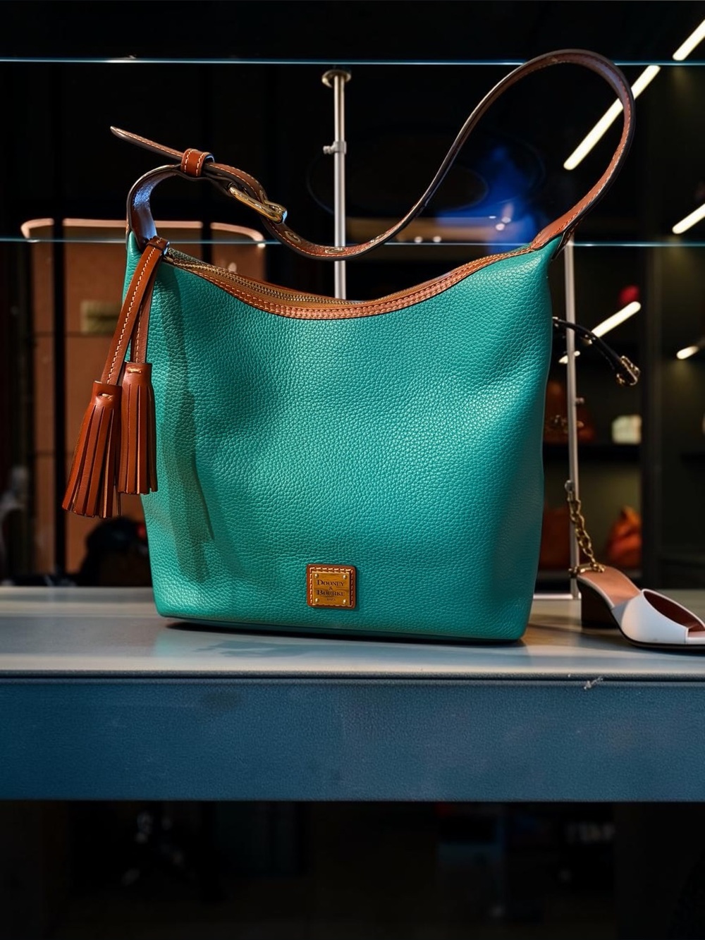 Dooney & Bourke Teal Pebbled Leather Shoulder Bag with Brown Trim and Tassel
